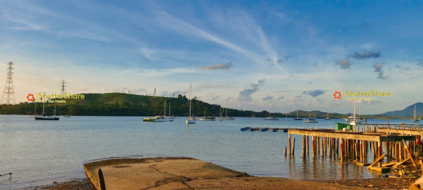 Peaceful Harbor with Sailboats at Sunset