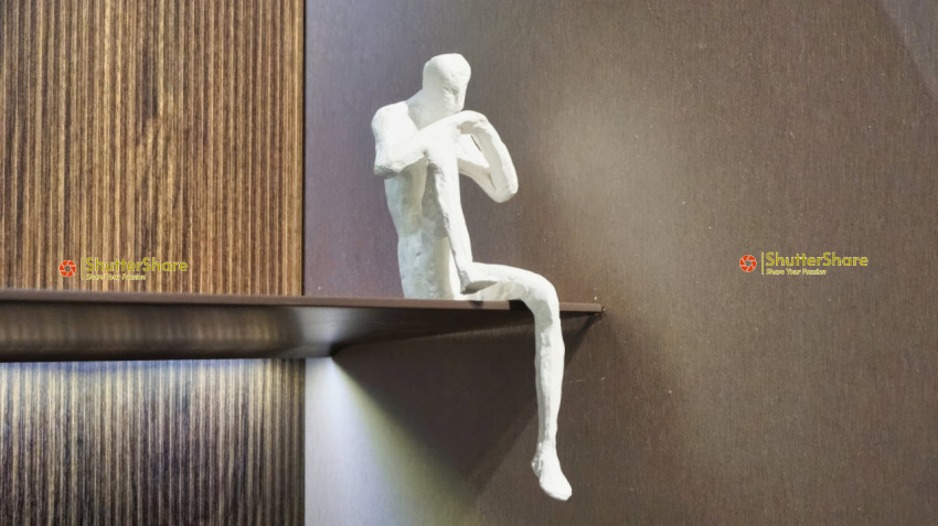 Contemplative Sculpture on Modern Shelf