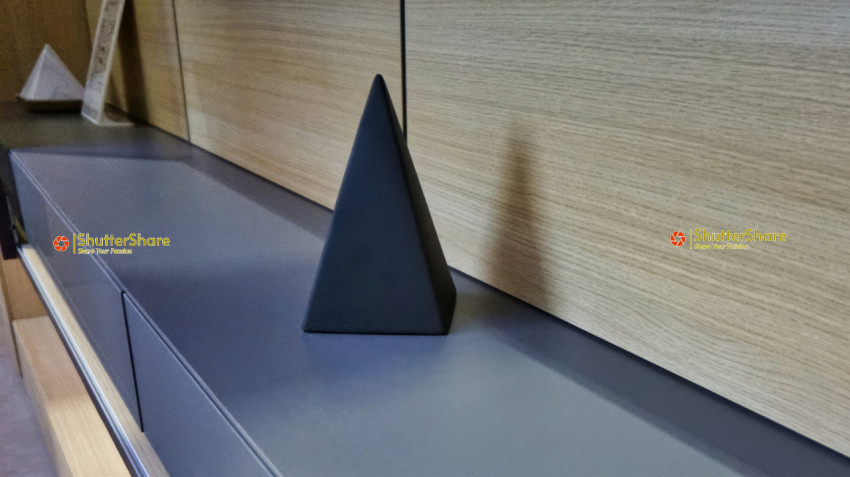 Modern Black Pyramid Decoration on Wooden Surface