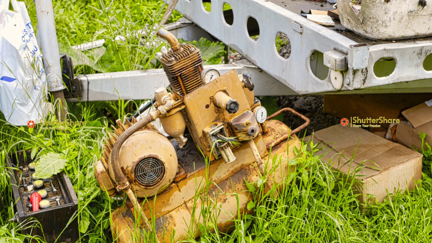 Rusty Machinery in Overgrown Grass