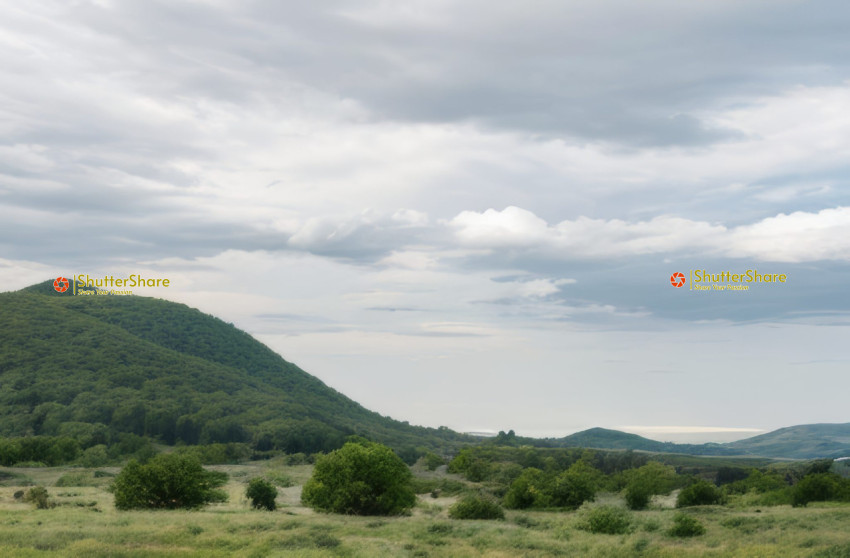 Rolling Hills Under a Cloudy Sky