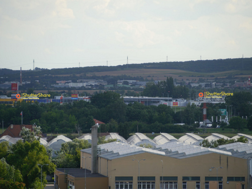 Industrial Skyline with Rolling Hills in the Distance