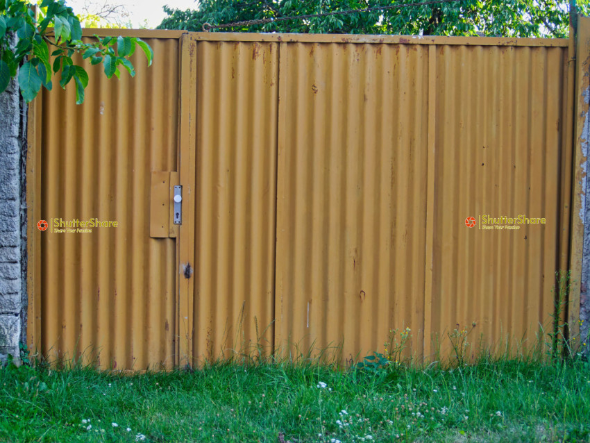 Rusty brown Gate with Concrete Wall