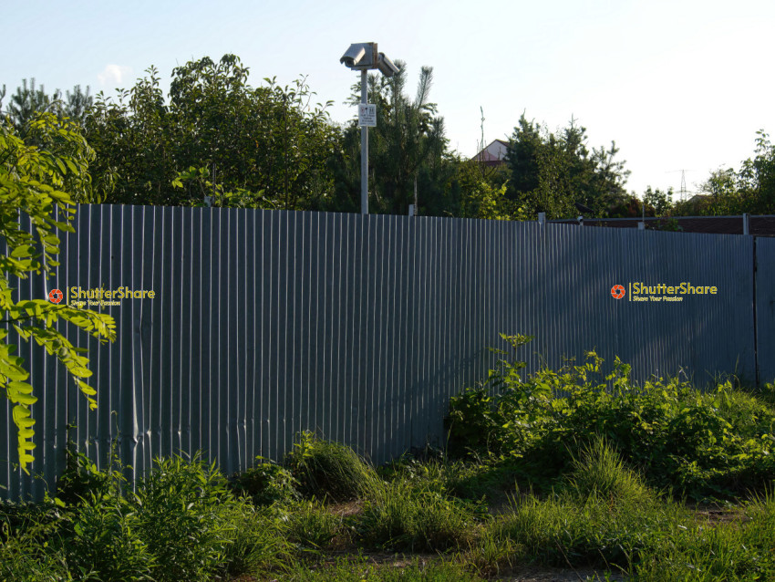 Security Camera on Corrugated Metal Fence