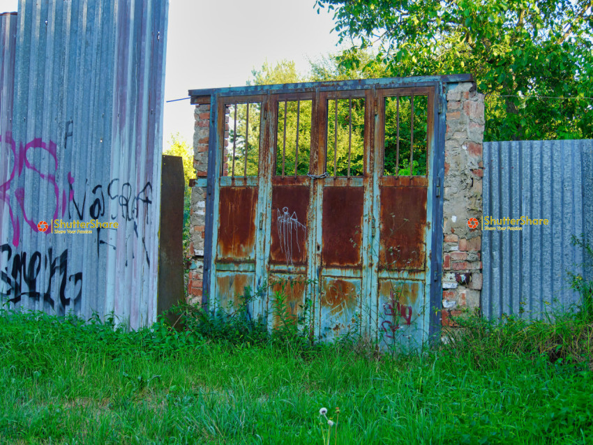 Rusty Gate with Graffiti