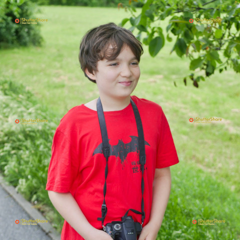 Young Boy with Camera in Park