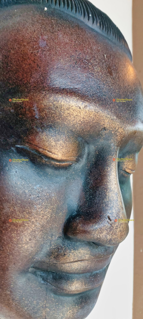 Close-up of a Bronze Buddha Statue Face